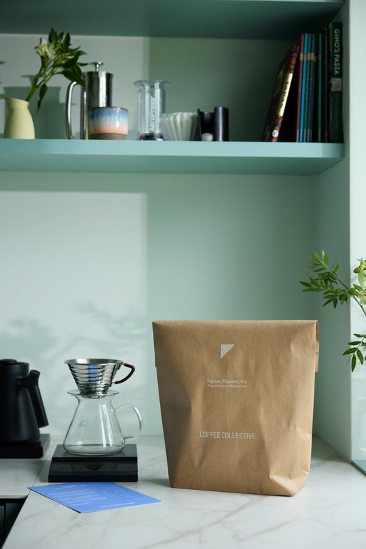 Brown coffee bag on a counter with a shelf in the background